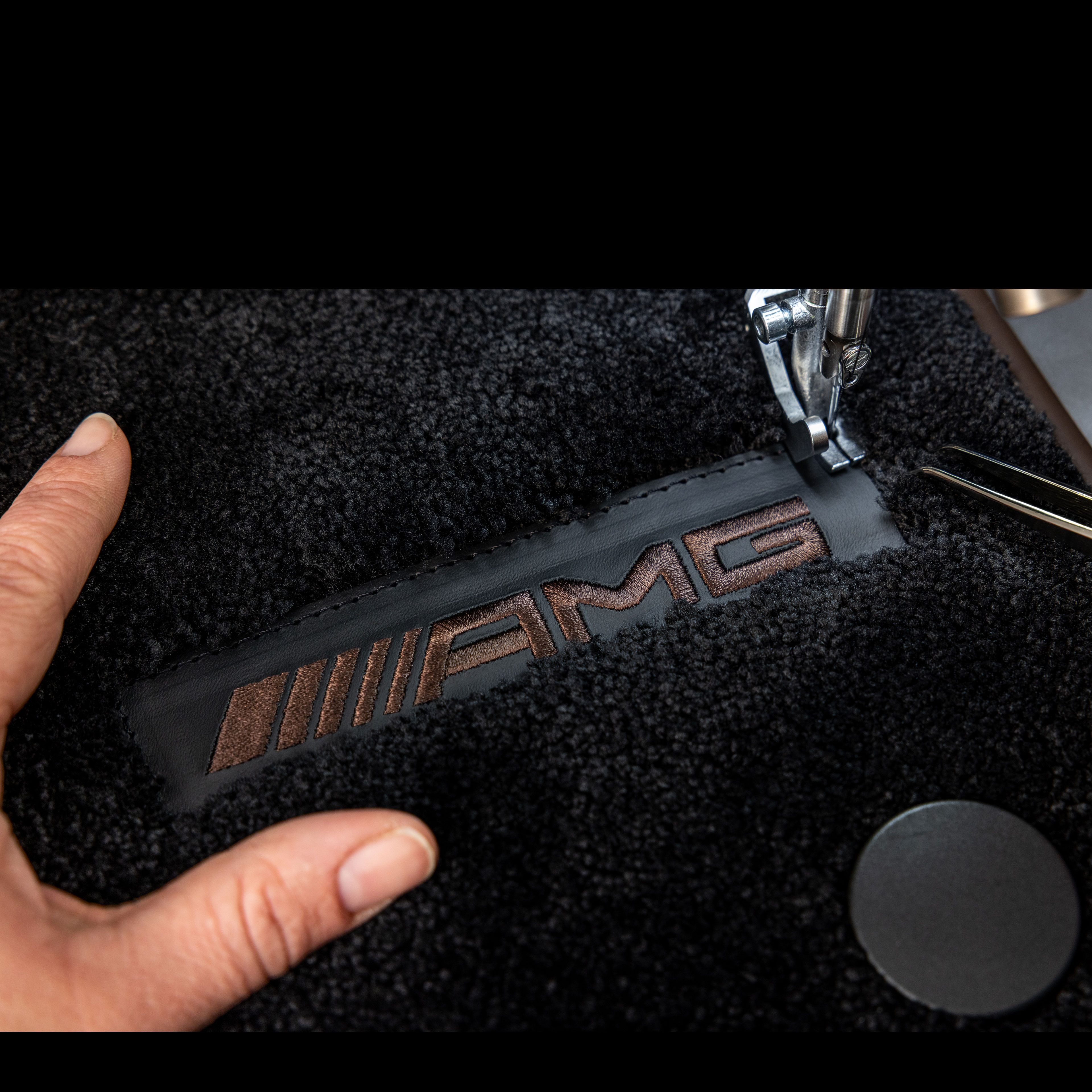 MANUFAKTUR | Mercedes-AMG Inscription MANUFAKTUR sur une surface foncée dans une Mercedes-AMG.