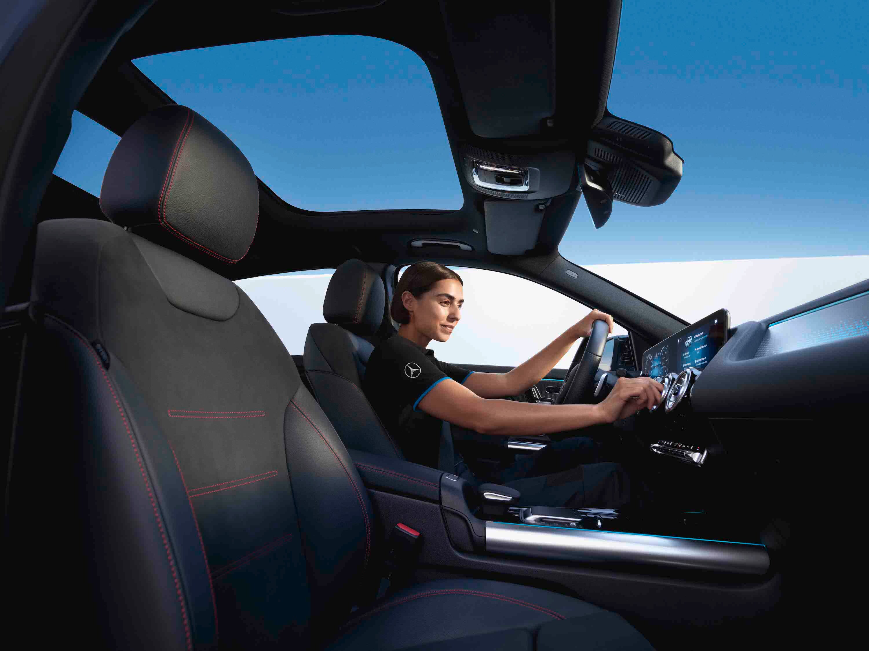 A technician sitting in the Mercedes-Benz vehicle and checking cabin air filter.