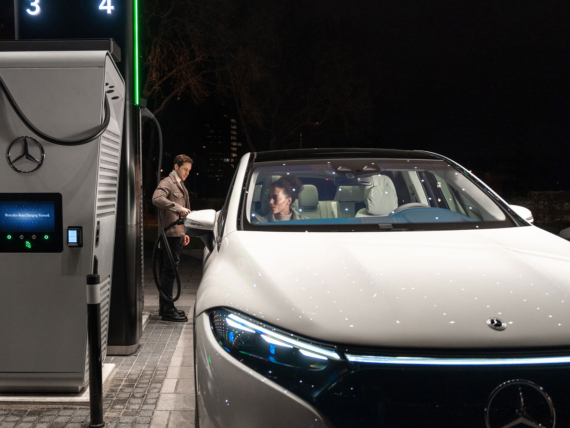 La Mercedes-Benz CLA ferma su una strada e collegata a una stazione di ricarica.