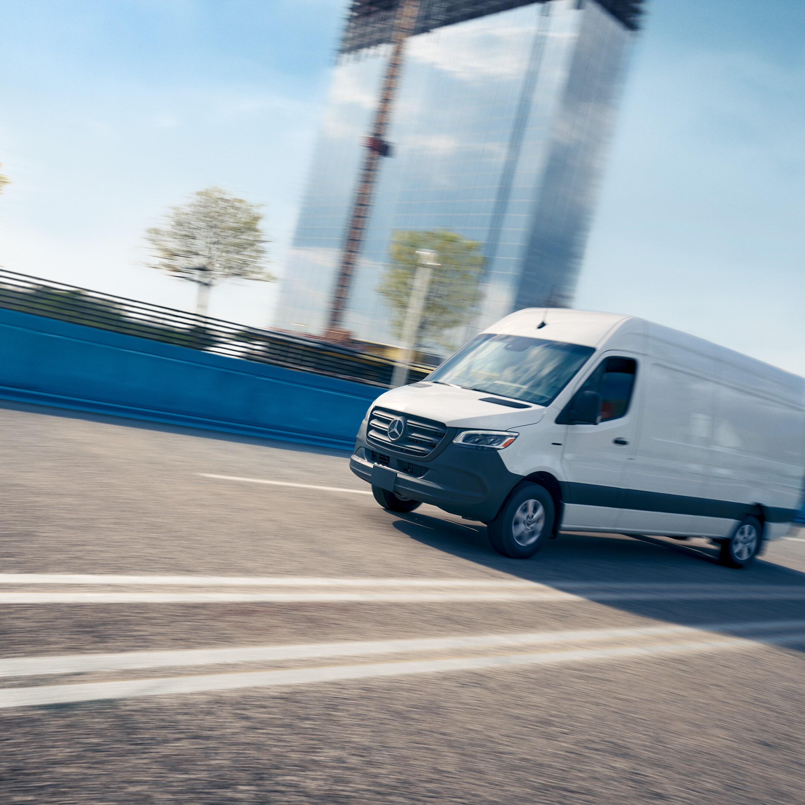 White van driving on a road, advertising for the Mercedes-Benz Service App with online appointment booking. 